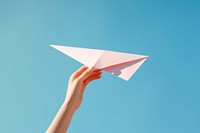 Hand holding paper plane origami airplane outdoors. AI generated Image by rawpixel.