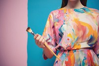 Hand holding paintbrush cosmetics painting standing. AI generated Image by rawpixel.