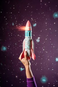 Hand holding a toy rocket exploration spacecraft ammunition. AI generated Image by rawpixel.
