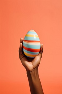 Hand holding a traditional easter egg ball celebration holiday. AI generated Image by rawpixel.