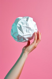 Hand holding small crumple paper ball origami art crumpled. AI generated Image by rawpixel.