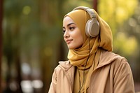 Indonesian woman headphones listening adult. AI generated Image by rawpixel.