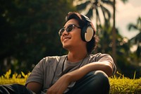 Singaporean man headphones listening glasses. AI generated Image by rawpixel.