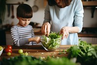 Preparing Salad cooking kitchen child. AI generated Image by rawpixel.