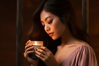 Woman smelling candle photography adult cup. AI generated Image by rawpixel.