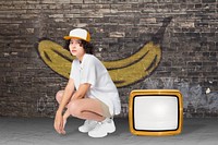 Cool girl in white shirt sitting by retro TV