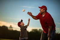 Father teaching son baseball throwing outdoors. AI generated Image by rawpixel.