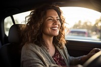 Latina perivien woman driving car laughing. 