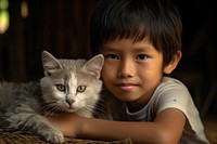 Thai kid with an Thai cat pet portrait mammal. AI generated Image by rawpixel.