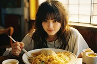 Japanese girl eating chopsticks plate table. AI generated Image by rawpixel.