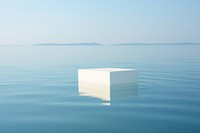 White product podium rests delicately on the surface of crystal-clear water outdoors horizon nature. AI generated Image by rawpixel.