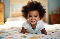 Cute baby african girl crawling on bed portrait smiling child. AI generated Image by rawpixel.
