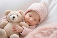 Newborn baby girl sleep with a teddy bear sleeping newborn blanket. 