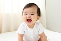 Cute baby asian laughing beginnings relaxation happiness. AI generated Image by rawpixel.