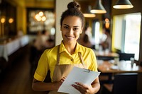 Photo of service woman holding the menu yellow entrepreneur restaurant. 