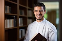 A smile student muslim men holding book publication portrait adult. AI generated Image by rawpixel.