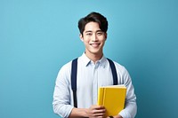 A smile student Taiwanese men holding book portrait intelligence publication. 