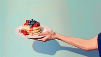Arm pancake berry fruit. AI generated Image by rawpixel.