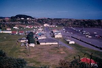 Panorama of Opunake Cove showing its attractive wide shelving beach ... (19 February 1961) by Leslie Adkin.