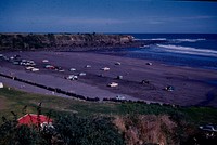 Panorama of Opunake Cove showing its attractive wide shelving beach ... (19 February 1961) by Leslie Adkin.