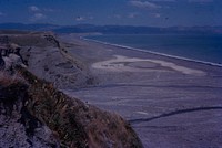 North-western shores of Palliser Bay from junction of river and seacliffs on right bank of Wharekauhau River above its mouth (21 January 1963) by Leslie Adkin.