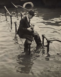 Press photographer, Victoria Embankment, during Spring tide London by Eric Lee Johnson.