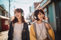 Japanese girls headphones listening street. AI generated Image by rawpixel.