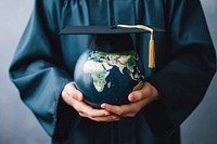 Hand holding earth globe with graduation cap education people intelligence. AI generated Image by rawpixel.