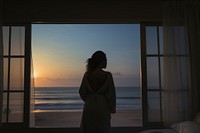 Woman wakes up window beach silhouette. AI generated Image by rawpixel.
