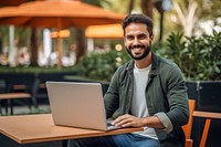 Mexican man working on laptop computer smiling sitting. AI generated Image by rawpixel.