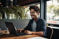 Mexican man working on laptop computer glasses smiling. AI generated Image by rawpixel.