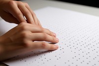 Hand reaches out to a braille page paper writing calligraphy handwriting. AI generated Image by rawpixel.