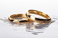 Two Golden Wedding Rings Sinking in Water ring jewelry wedding. AI generated Image by rawpixel.