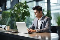 Asian young business man sales manager making phone call laptop computer office. 