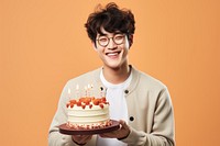 Happy Korean man birthday party cake dessert smile. AI generated Image by rawpixel.