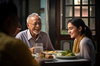 Senior man and senior women and a girl teenager south asian restaurant adult happy. 