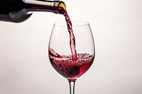 Pouring red wine in a glass pouring bottle drink. AI generated Image by rawpixel.