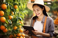 Asian woman farmer working in orange farm computer smiling fruit. AI generated Image by rawpixel.