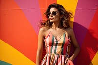 Latina woman in a sundress standing in front of a colorful wall fashion sunglasses summer. AI generated Image by rawpixel.