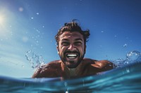 Summer atractive happy Latino man swimming with goggles in the sea recreation underwater. AI generated Image by rawpixel.