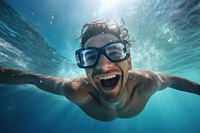 Summer atractive happy Latino man swimming with goggles in the sea underwater recreation. AI generated Image by rawpixel.