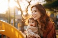 Smiling Japanese mother carrying portrait outdoors. AI generated Image by rawpixel.