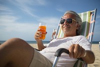 Male latinx in holding soda can while sitting on beach chair photography sunbathing sunglasses. AI generated Image by rawpixel.