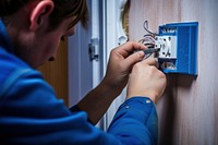 Hands repairing a electrical socket electricity technology protection. 