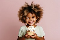 Child hold cupcake portrait smiling dessert. AI generated Image by rawpixel.