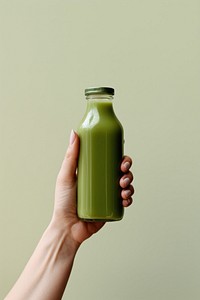 Green juice smoothie holding bottle. AI generated Image by rawpixel.