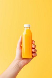 Orange juice bottle holding drink. AI generated Image by rawpixel.