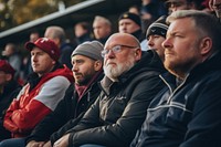 People are watching audience football sports. 