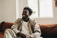 Black man sitting laughing adult. AI generated Image by rawpixel.
