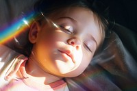 Rainbow light on newborn face photography portrait sleeping. AI generated Image by rawpixel.